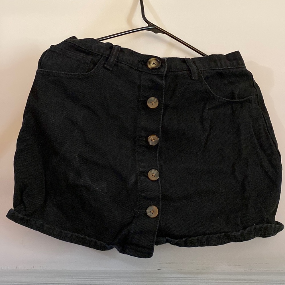 Black skirt with brown buttons.